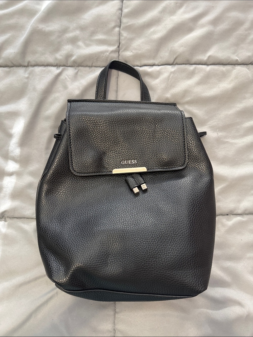 GUESS Black Pebbled Drawstring Backpack with Gold Accent